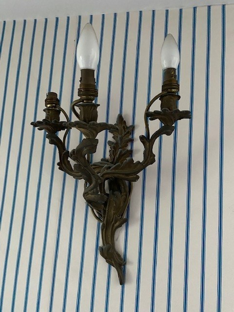 A set of three rococo style gilt metal twin branch wall lights, height 45cm